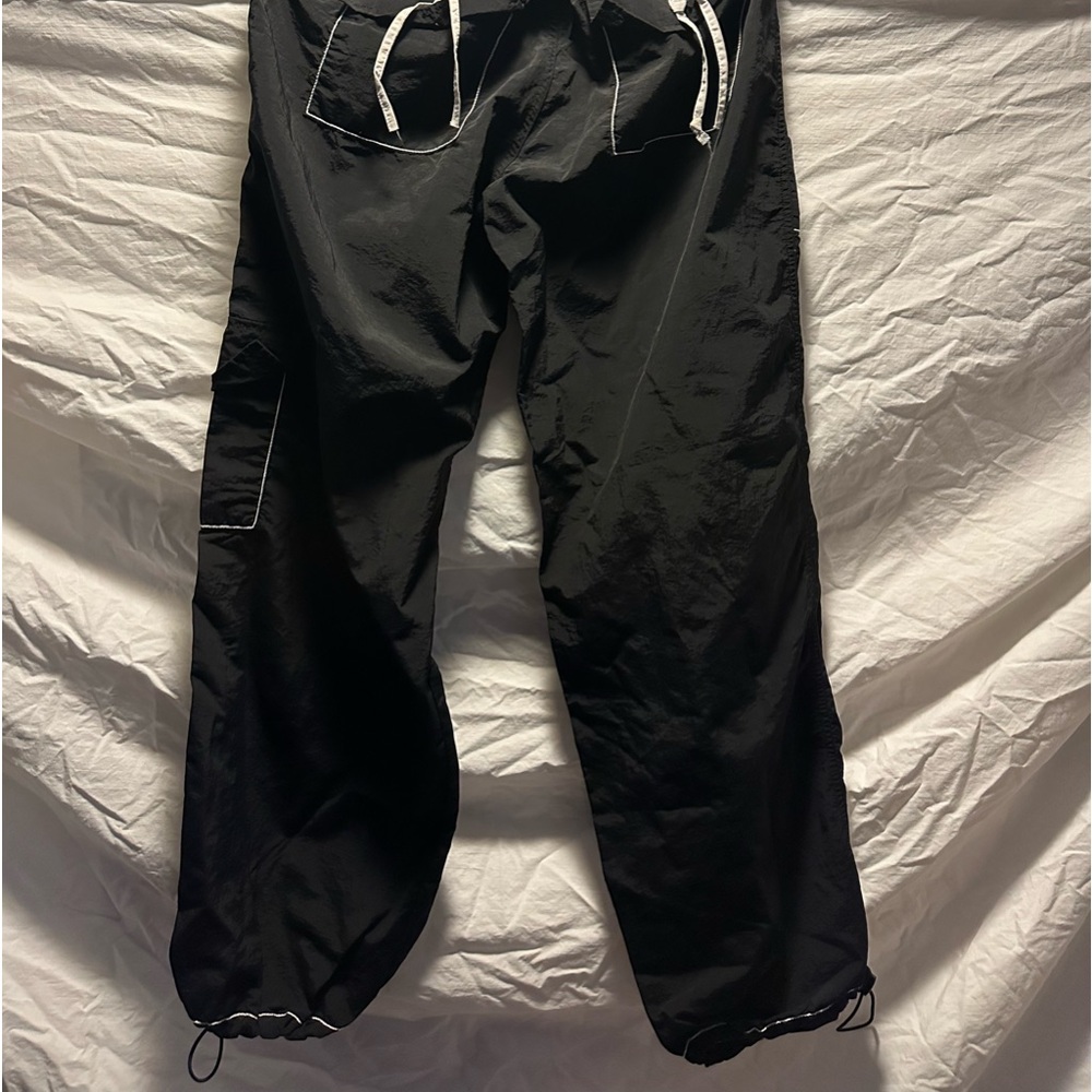 Cargo parachute pants black, and white tag is large, but more like medium large